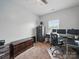 Neutral-toned bedroom with space for office, carpet floors, and a secure storage cabinet at 6017 Fazio Ct, Harrisburg, NC 28075