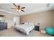 Bedroom with ceiling fan, neutral carpet, and a glimpse of a side table and doorway at 6017 Fazio Ct, Harrisburg, NC 28075