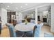 Open-concept dining area featuring a round table with upholstered chairs next to the kitchen and living room at 6017 Fazio Ct, Harrisburg, NC 28075