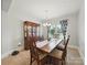 Bright dining room featuring a table with chairs, hardwood floors, and decorative hutch at 6017 Fazio Ct, Harrisburg, NC 28075