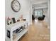 Inviting entryway with light wood floors, console table and decorative elements leading to living area at 6017 Fazio Ct, Harrisburg, NC 28075