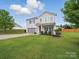 Traditional two-story home with attached garage, manicured lawn and landscaping at 6017 Fazio Ct, Harrisburg, NC 28075