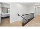 Hallway featuring carpeted stairs and view into bedroom at 6017 Fazio Ct, Harrisburg, NC 28075