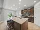 Modern kitchen with a granite island, stylish dark wood cabinets, stainless appliances, and recessed lighting at 6017 Fazio Ct, Harrisburg, NC 28075