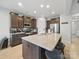 Modern kitchen with a granite island, stylish dark wood cabinets, stainless appliances, and recessed lighting at 6017 Fazio Ct, Harrisburg, NC 28075