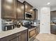 Kitchen featuring stainless steel appliances, granite countertops and dark cabinets at 6017 Fazio Ct, Harrisburg, NC 28075