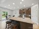 Kitchen island featuring granite countertop, stainless steel appliances and bar stool seating at 6017 Fazio Ct, Harrisburg, NC 28075