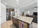 Kitchen island featuring granite countertop, stainless steel appliances and view of the stairs and living room at 6017 Fazio Ct, Harrisburg, NC 28075