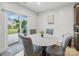 Eat-in kitchen with round table, four upholstered chairs and a sliding glass door providing outdoor views at 6017 Fazio Ct, Harrisburg, NC 28075