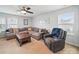 Living room featuring carpet flooring, a ceiling fan and comfortable furniture at 6017 Fazio Ct, Harrisburg, NC 28075
