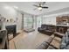 Living room featuring a fireplace, ceiling fan, hardwood floors and leather furniture at 6017 Fazio Ct, Harrisburg, NC 28075