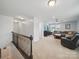 Loft with carpet flooring and view of the living room at 6017 Fazio Ct, Harrisburg, NC 28075