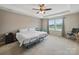 Spacious main bedroom featuring carpet flooring, a ceiling fan and natural light at 6017 Fazio Ct, Harrisburg, NC 28075