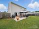 Backyard patio with gazebo, outdoor seating, and grill at 6017 Fazio Ct, Harrisburg, NC 28075