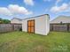 Storage shed in fenced backyard with green grass at 6017 Fazio Ct, Harrisburg, NC 28075