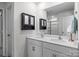 Bright bathroom features a double vanity with sleek countertops, a large mirror, and ample storage in the wall cabinet at 7172 Teague Dr, Gastonia, NC 28056