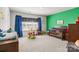 bedroom features a crib, toys, a green accent wall, and natural light creating a playful and inviting space at 7172 Teague Dr, Gastonia, NC 28056