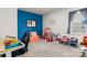 Blue-accented bedroom with a play area, desk, and grey carpet, creating a versatile space at 7172 Teague Dr, Gastonia, NC 28056