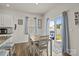 Bright eat-in kitchen boasts a wooden dining table, seating for four, and sliding glass doors for seamless outdoor access at 7172 Teague Dr, Gastonia, NC 28056