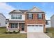 Well-maintained two-story home featuring a classic brick facade and a two-car garage, set in a residential neighborhood at 7172 Teague Dr, Gastonia, NC 28056