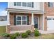 Charming front porch with brick and siding, featuring well-kept landscaping and a welcoming entrance at 7172 Teague Dr, Gastonia, NC 28056