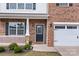 Inviting front entrance with a cozy porch, brick accents, and lush landscaping, creating a warm welcome at 7172 Teague Dr, Gastonia, NC 28056