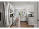 Bright kitchen with white cabinetry, stainless steel appliances, and hardwood floors, offering a modern culinary space at 7172 Teague Dr, Gastonia, NC 28056