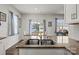 Granite countertops complement the double sink and faucet in this well-lit kitchen, complete with stainless steel appliances at 7172 Teague Dr, Gastonia, NC 28056