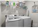 Laundry room featuring modern LG washer and dryer, wire shelving, and laundry themed decor at 7172 Teague Dr, Gastonia, NC 28056