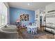 Cozy living room with stylish decor, including a play area, seating, and access to the kitchen at 7172 Teague Dr, Gastonia, NC 28056