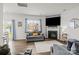 Bright living room with modern fireplace, large TV, plush seating, and seamless transition to outdoor living through sliding glass doors at 7172 Teague Dr, Gastonia, NC 28056