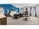 Spacious main bedroom with a blue accent wall, carpet flooring, and ample natural light from two windows at 7172 Teague Dr, Gastonia, NC 28056