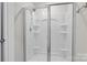 Modern shower features a glass door, sleek fixtures, and built-in shelves for convenient storage at 7172 Teague Dr, Gastonia, NC 28056