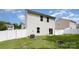 Backyard featuring green grass, a white fence, and a built-in fire pit at 7209 Cuddington Dr, Charlotte, NC 28215