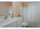 Traditional bathroom featuring peach walls, framed artwork, and a shower-tub combo at 7209 Cuddington Dr, Charlotte, NC 28215