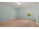 Bright bedroom featuring neutral carpet, light green walls, and natural light at 7209 Cuddington Dr, Charlotte, NC 28215