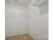 A walk-in closet contains white shelves at 7209 Cuddington Dr, Charlotte, NC 28215