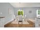 Cozy dining area with a modern chandelier, comfortable seating, and a view of the backyard at 7209 Cuddington Dr, Charlotte, NC 28215