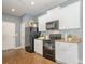 Functional kitchen with white cabinetry, black appliances, and granite countertops, perfect for everyday cooking at 7209 Cuddington Dr, Charlotte, NC 28215