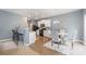 Open-concept kitchen featuring white cabinets, black appliances, and a dining area for easy entertaining at 7209 Cuddington Dr, Charlotte, NC 28215