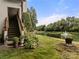 Scenic backyard view with a tranquil pond, fountain, lush greenery, and wooden staircase at 7329 Winery Ln, Charlotte, NC 28227
