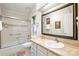 Updated bathroom featuring a glass-enclosed shower and a large decorative mirror at 7329 Winery Ln, Charlotte, NC 28227