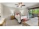 Comfortable bedroom with ceiling fan, access to patio, and light, neutral tones at 7329 Winery Ln, Charlotte, NC 28227