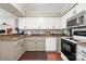 Bright kitchen featuring white cabinets, stainless steel appliances, and modern countertops at 7329 Winery Ln, Charlotte, NC 28227