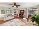 Spacious living room featuring hardwood floors, a ceiling fan, comfortable seating, and access to the patio at 7329 Winery Ln, Charlotte, NC 28227