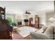 Bright living room with a fireplace, ceiling fan, hardwood floors, and ample seating at 7329 Winery Ln, Charlotte, NC 28227