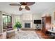 Comfortable living room with a fireplace, ceiling fan, and large sliding glass doors at 7329 Winery Ln, Charlotte, NC 28227