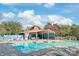 Community pool with lounge chairs and shade structure surrounded by lush greenery on a sunny day at 7329 Winery Ln, Charlotte, NC 28227