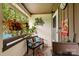 Cozy porch with comfortable seating, hanging plants, and decorative butterfly art at 7329 Winery Ln, Charlotte, NC 28227