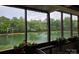 Relaxing screened porch view with flowering plants overlooking the community pond and fountain at 7329 Winery Ln, Charlotte, NC 28227